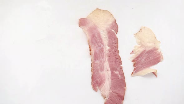Raw Fed Bacon Strips on White Background  Top View