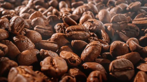 Close Up of Seeds of Coffee. Fragrant Coffee Beans Are Roasted Smoke Comes From Coffee Beans