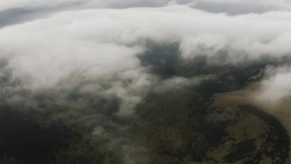 Aerial View, Flying over autumn forest mountains with beautiful clouds, Slovakia