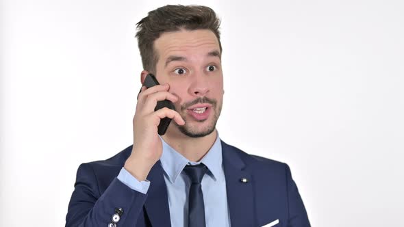 Portrait of Upset Young Businessman Getting Angry on Smartphone , White Background