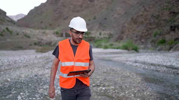 Engineer Investigates in Electric Water Dam