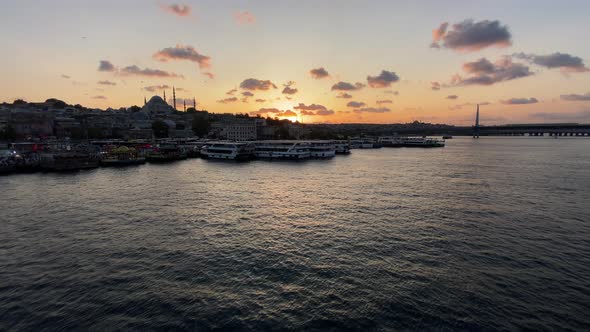 Slow Tilt Up Revealing Golden Horn Bosphorus and Istanbul Cityscape in Beautiful Sunsets with Mosque