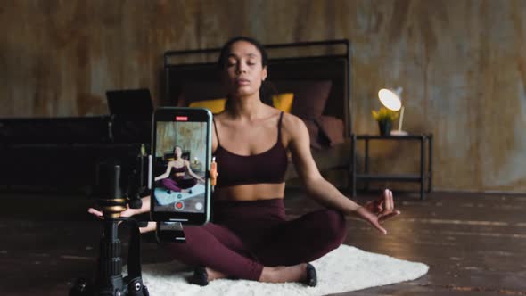 Young Attractive African American Woman Blogger Recording Video with a Smartphone Live Streaming