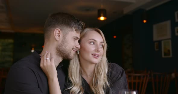 Beautiful People Man and Woman Hugging at Restaurant