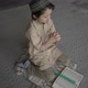 Little boy in prayer hat and arabic clothes with rosary beads and Koran book praying to God - VideoHive Item for Sale