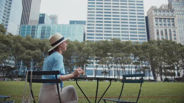 Young girl having breakfast in a famous park