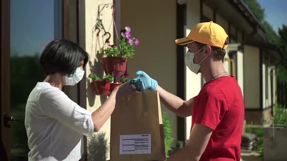 Male Worker Gives To Elderly Woman Paper Bag and Says Goodbye Outdoors Spbd