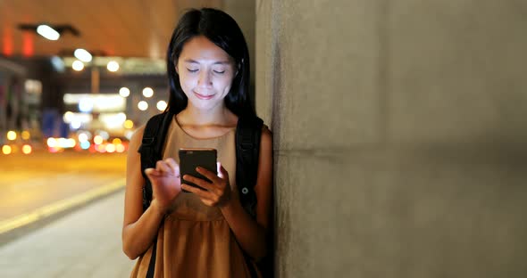 Asian woman use of cellphone in the city