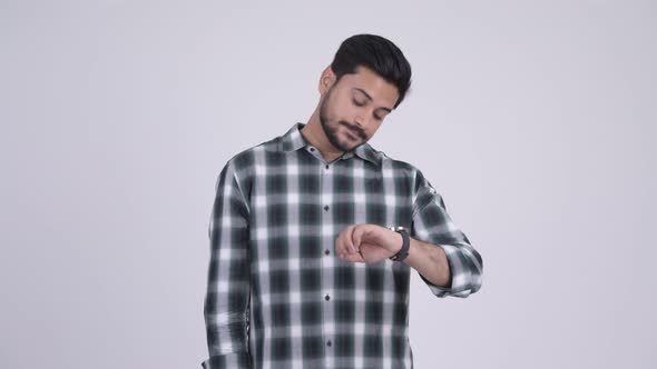 Portrait of Young Bearded Indian Man Looking Tired and Bored