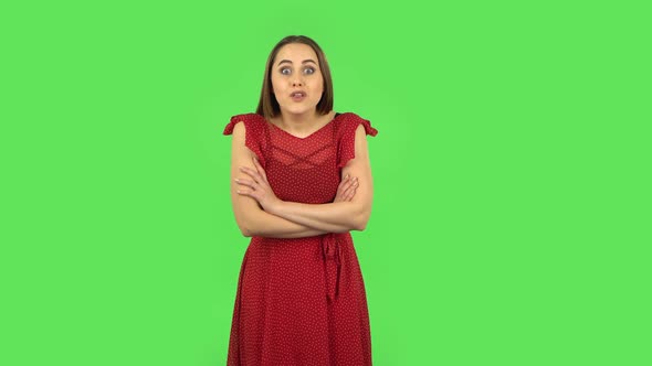 Tender Girl in Red Dress Is Listening To Information, Shocked and Smiling. Green Screen