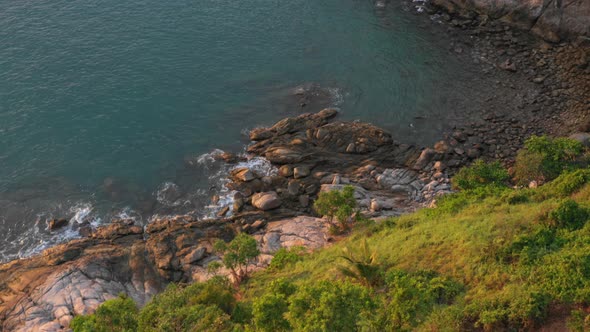 Aerial View Waves Hit The Rock In Green Sea At Promthep Cape Viewpoint Phuket.