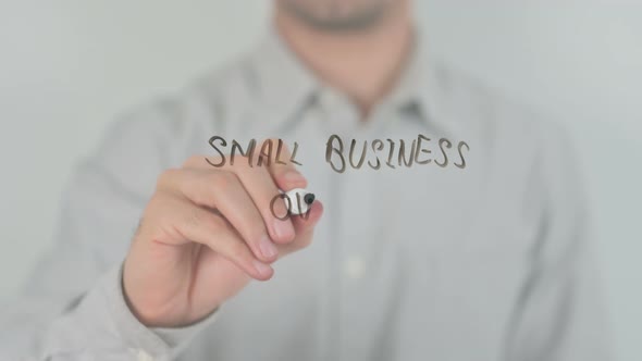 Small Business Owner Writing on Screen with Hand