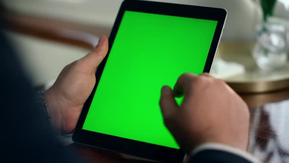 Manager Hand Swiping Green Tablet Screen Closeup