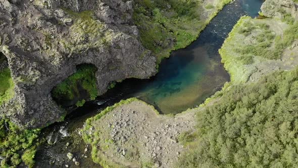 Winding river flowing through green valley