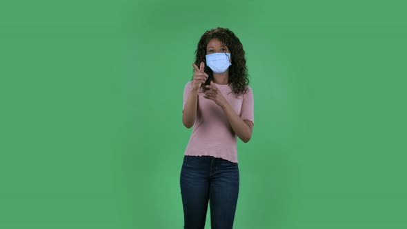 Portrait of Beautiful African American Young Woman in Medical Protective Face Mask Looking at Camera