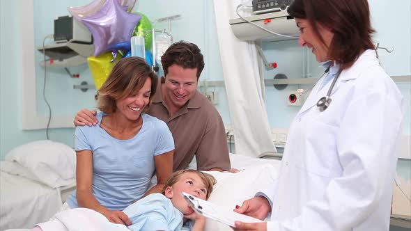 Smiling parents next to a doctor