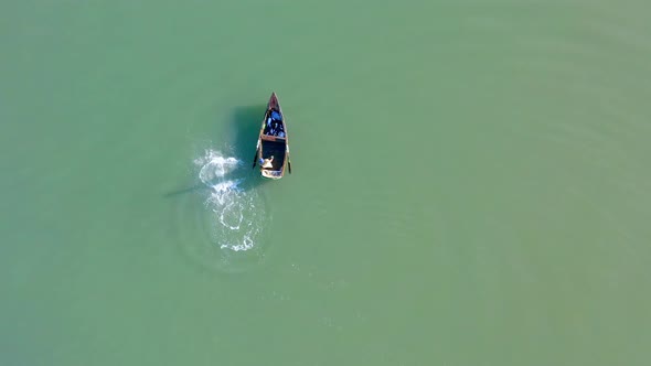 Aerial top-down forward over fisherman in Soco River mouth with fishing criminal method, Dominican R