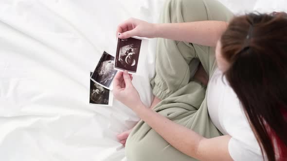 Top View Cropped of Pregnant Woman Looking Ultrasound Photo of Fetus Standing at Home Young Future