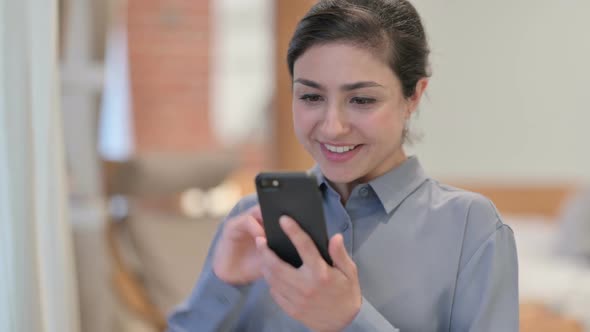 Portrait of Young Indian Woman Celebrating on Smartphone