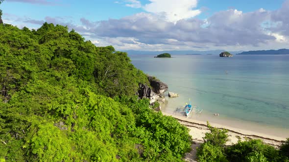 Nature Landscape: Sandy Tropical Beach with Crystal Clear Sea. Rocks and Tropical Beach in Caramoan