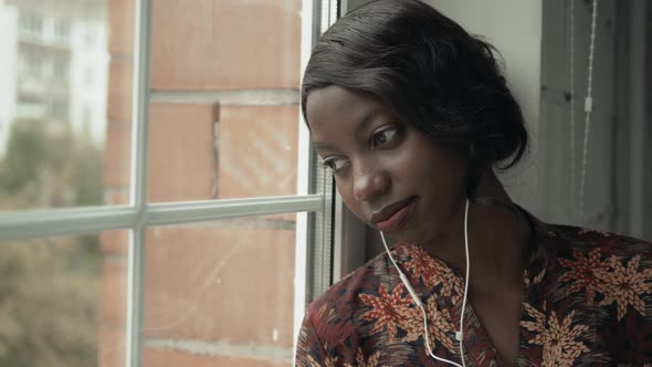 Young Black Woman Listening Music Travelling Looking Outdoor the Window, Pensive - Thoughtful