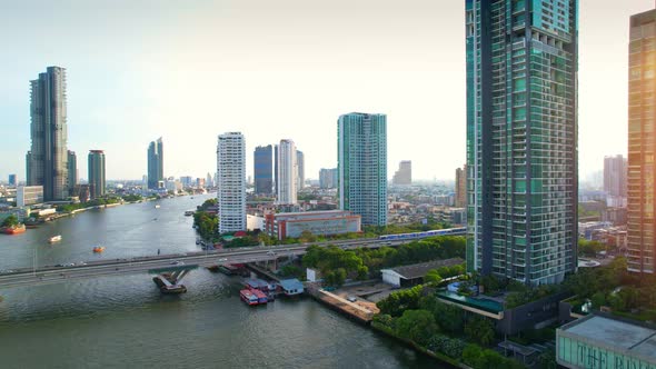 4K : Drones fly over the Chao Phraya River, buildings and business districts in Bangkok