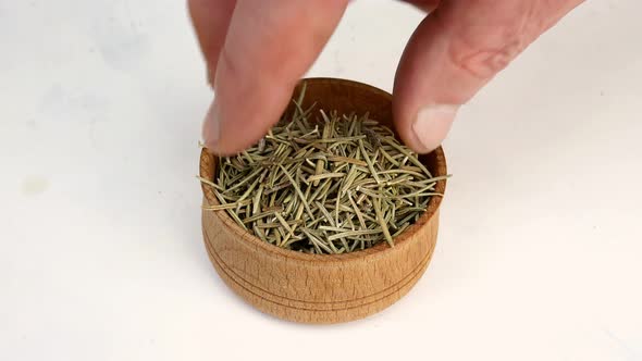 Chef Taking with Fingers Spices Dry Rosemary From Wooden Spice Jar for Cooking Savory Tasty Food