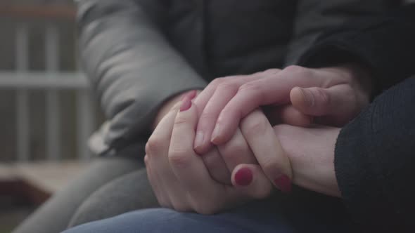 Close-up of Caucasian Man's and Woman's Hands on Top of Each Other. Cheerful Unrecognizable