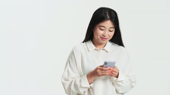 Beautiful asian korean woman using her phone