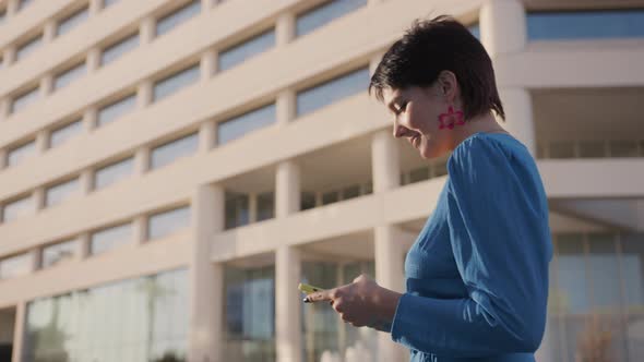 Cheerful Woman Typing Phone Scrolling Media