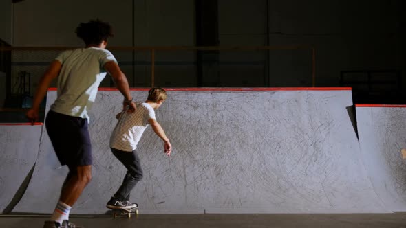 Male friends practicing skateboarding 4k