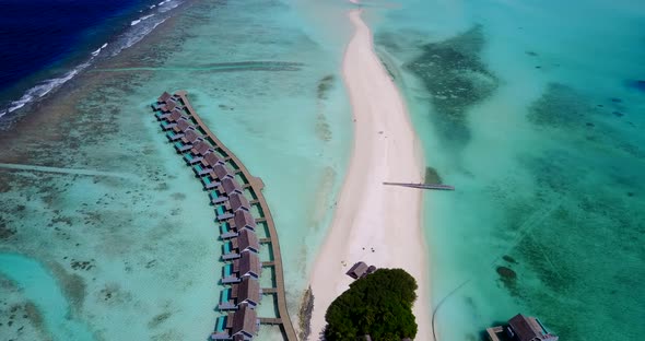 Tropical aerial island view of a sunshine white sandy paradise beach and aqua turquoise water backgr