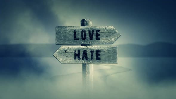 Old Wooden Sign On A Middle Of A Cross Road With The Words Love Or Hate