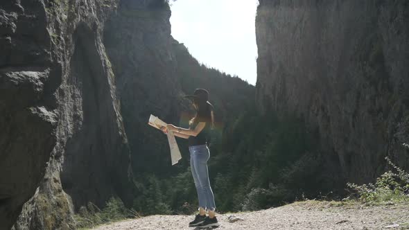 Beautiful Women with Touristic Map in Trigrad, Shiroka Laka, Bulgaria. Happy Girl Enjoy Bulgarian