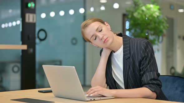 Tired Businesswoman with Laptop Having Neck Pain 