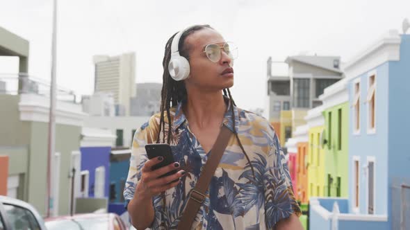 Mixed race man listening to music with headphone