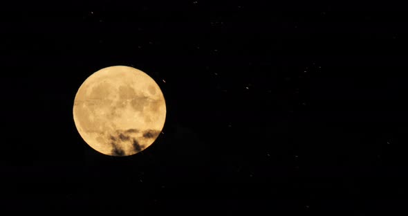 A firework in front of the Super full moon in the french sky