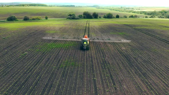 Aerial View Farm Machinery Spraying Insecticide To the Green Field, Agricultural Natural Seasonal