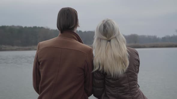 Back View of Blond Woman Putting Head on Man's Shoulder. Middle Shot of Married Loving Caucasian