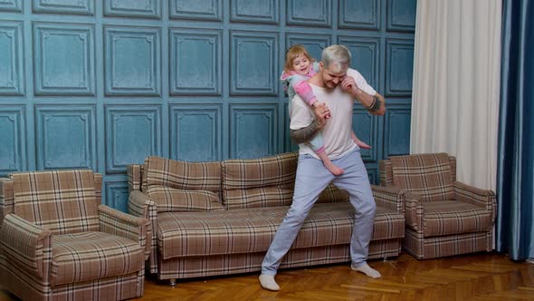 Happy Family Father and Child Kid Daughter Dancing Playing Piggyback Running Riding at Home