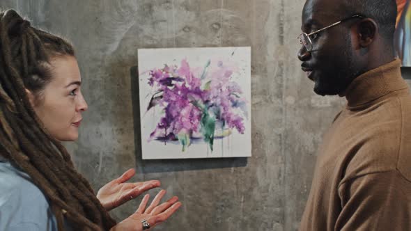 Couple Discussing Paintings on Exhibition