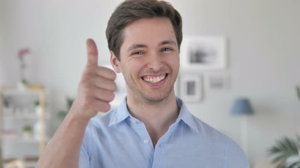 Thumbs Up by Excited Handsome Young Man