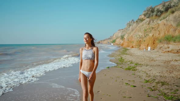 Slow Motion of Happy Joyful Slim Fitbody Woman Wearing in Bikini and Enjoying Wind and Waves on Sea