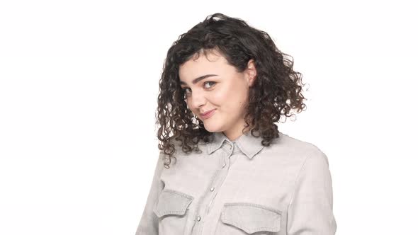 Portrait of Cute Curly Woman with Round Face Embarrassing and Blushing While Posing on Camera Over