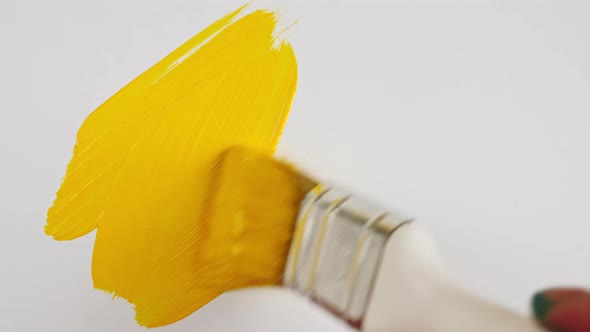 Abstract Brushstrokes of Yellow Paint Brush Applied Isolated on a White Background