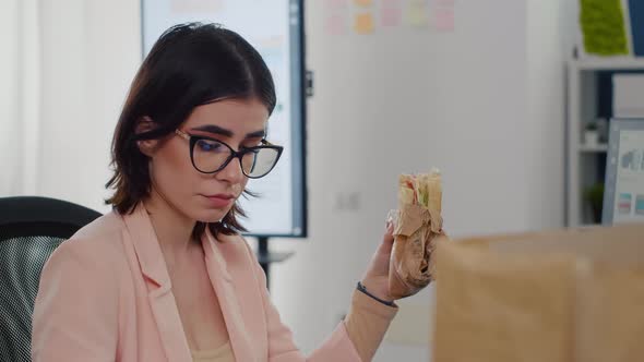 Entrepreneur Woman Eating Tasty Sandwich Having Work Break Working in Business Company