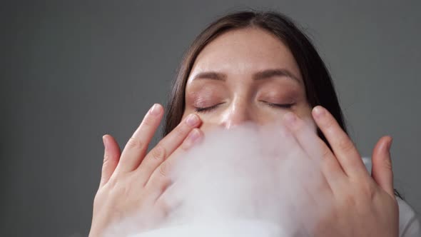Woman Doing Steam Therapy with Humidifier Sitting in Room