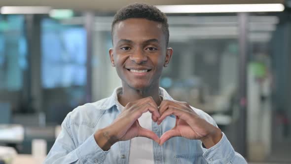 Portrait of African Man showing Heart Sign by Hand