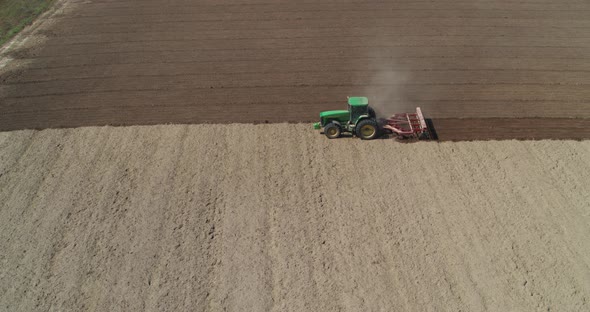 Tractor on the Field Working Aerial View