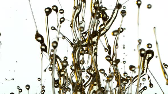 Super Slow Motion Shot of Splashing Oil Isolated on White Background at 1000Fps.